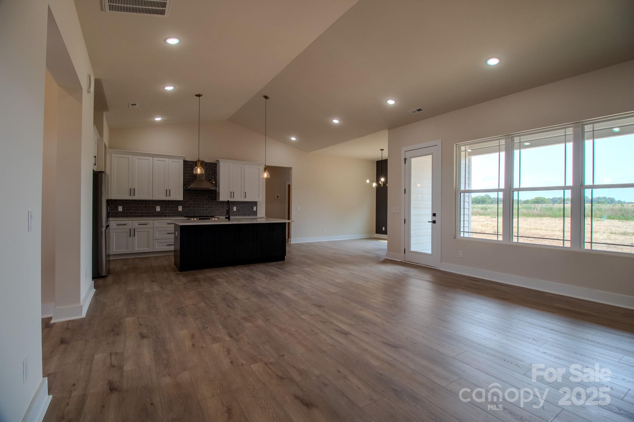 1429 Coppergate Drive Salisbury, NC 28147 - Photo 7 of 37 a kitchen with stainless steel appliances kitchen island granite countertop a refrigerator and a stove top oven