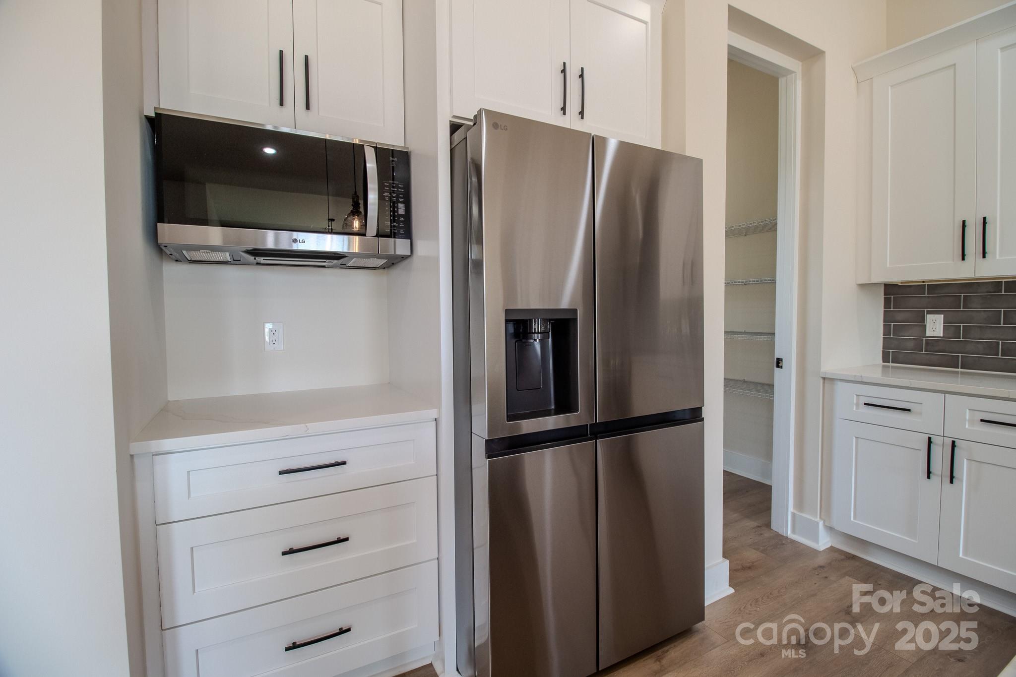 1429 Coppergate Drive Salisbury, NC 28147 - Photo 10 of 37 a view of a bedroom with a flat screen tv and refrigerator
