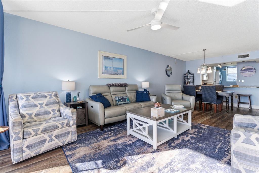 15462 Gulf Boulevard, Unit 406 Madeira Beach, FL 33708 - Photo 12 of 48 a living room with furniture and a chandelier