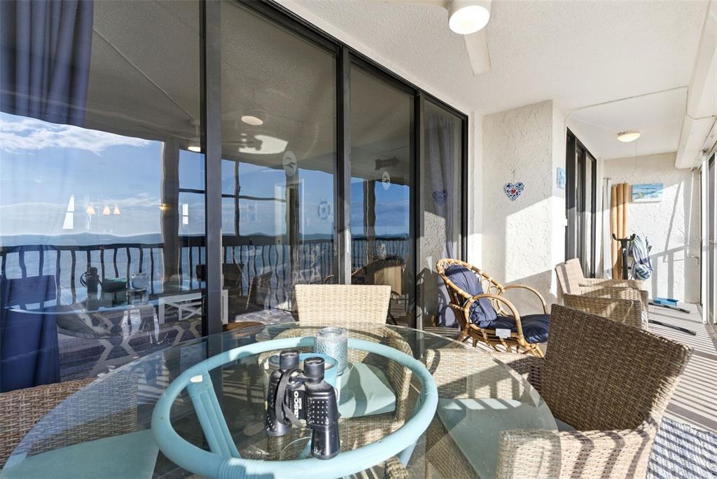 15462 Gulf Boulevard, Unit 406 Madeira Beach, FL 33708 - Photo 15 of 48 a view of a dining room with furniture wooden floor and chandelier