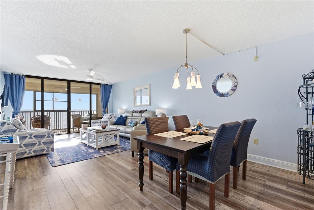 15462 Gulf Boulevard, Unit 406 Madeira Beach, FL 33708 - Photo 16 of 48 a view of a dining room with furniture window and wooden floor