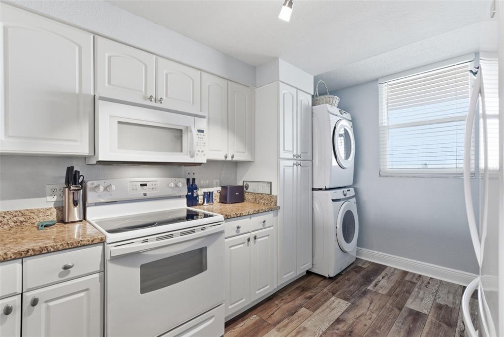 15462 Gulf Boulevard, Unit 406 Madeira Beach, FL 33708 - Photo 20 of 48 a kitchen with a refrigerator sink and cabinets
