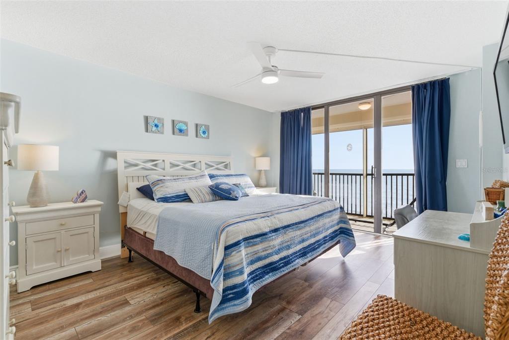 15462 Gulf Boulevard, Unit 406 Madeira Beach, FL 33708 - Photo 24 of 48 a bedroom with a bed and a large window
