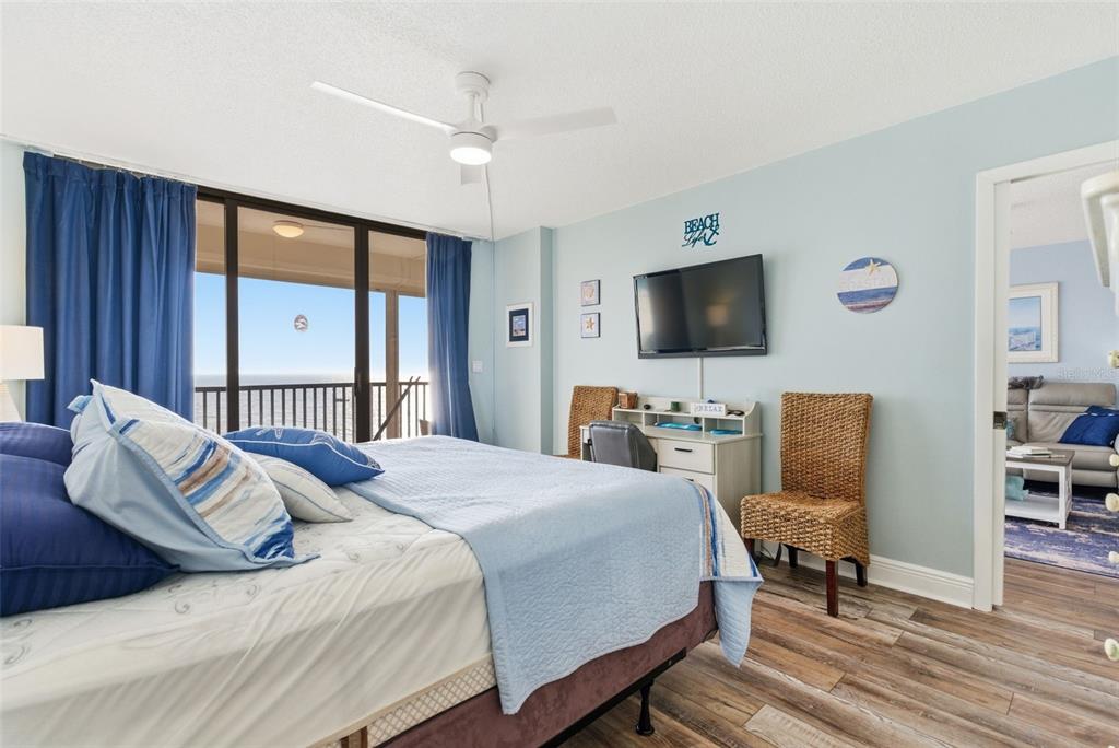 15462 Gulf Boulevard, Unit 406 Madeira Beach, FL 33708 - Photo 25 of 48 a bedroom with a bed and a flat screen tv