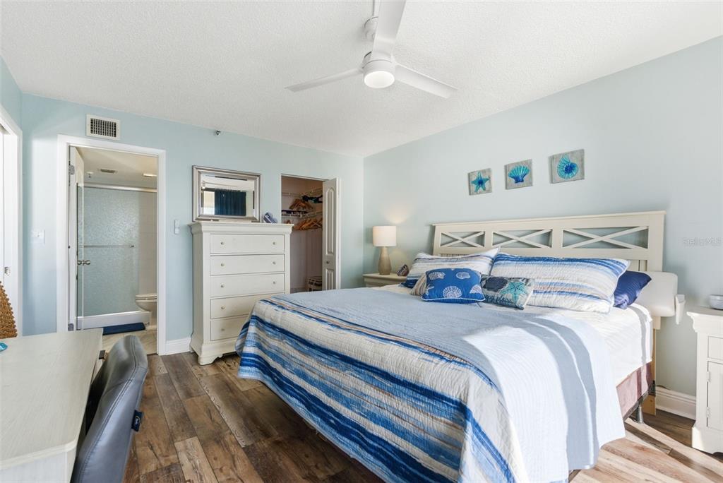 15462 Gulf Boulevard, Unit 406 Madeira Beach, FL 33708 - Photo 26 of 48 a bedroom with a bed and a dresser