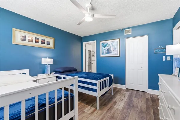 a bathroom with a granite countertop sink a toilet and shower