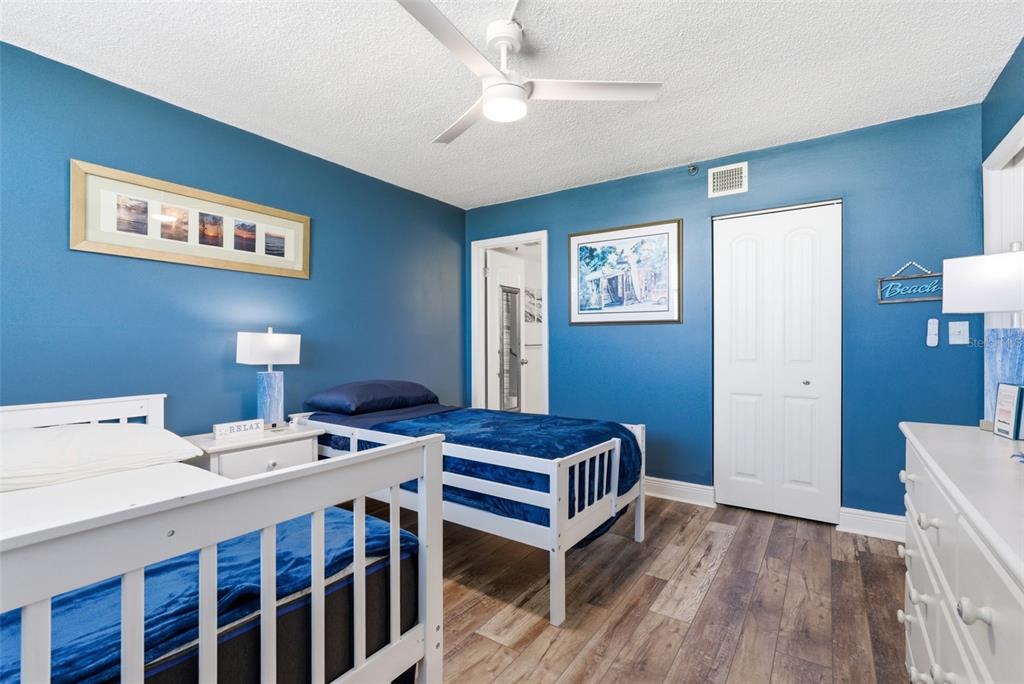 15462 Gulf Boulevard, Unit 406 Madeira Beach, FL 33708 - Photo 29 of 48 a bedroom with a bed and a table in it