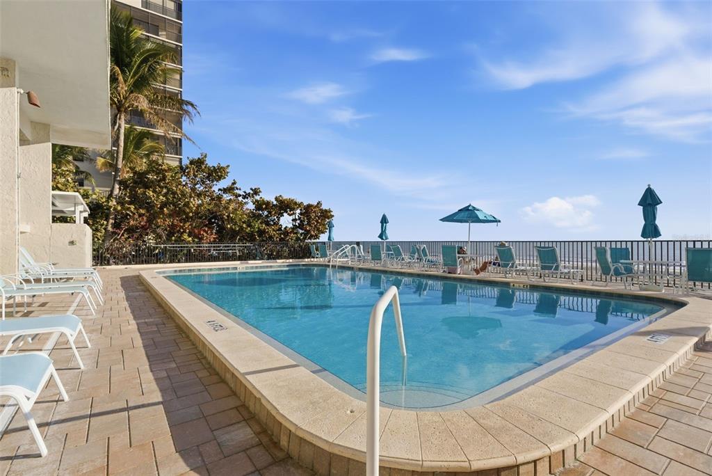 15462 Gulf Boulevard, Unit 406 Madeira Beach, FL 33708 - Photo 33 of 48 a view of a swimming pool with a terrace