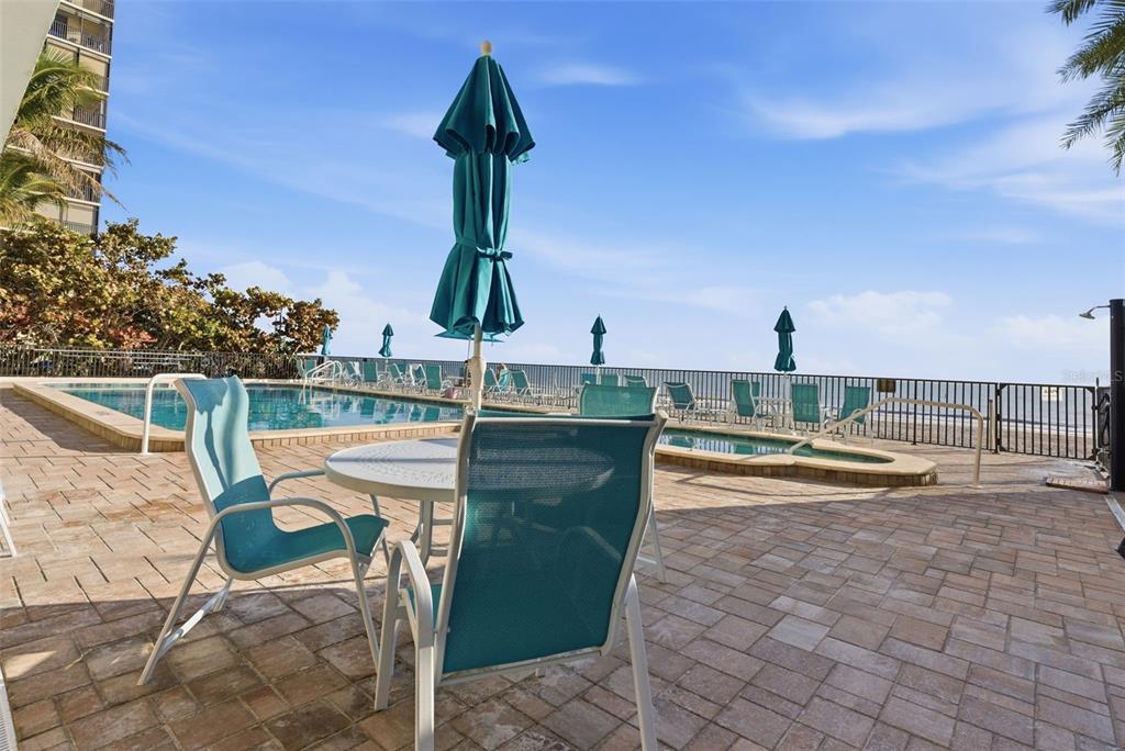 15462 Gulf Boulevard, Unit 406 Madeira Beach, FL 33708 - Photo 35 of 48 a view of a swimming pool with a lounge chair