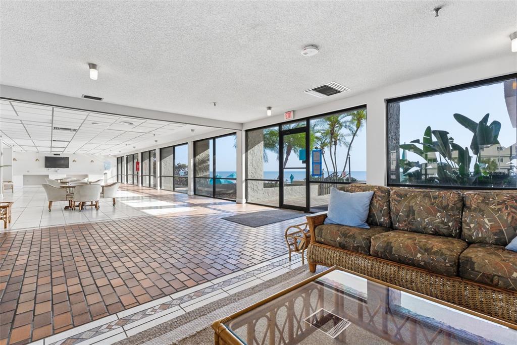 15462 Gulf Boulevard, Unit 406 Madeira Beach, FL 33708 - Photo 39 of 48 a living room with furniture and a large window