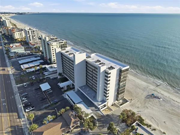 an aerial view of residential building and ocean view