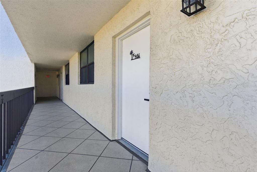 15462 Gulf Boulevard, Unit 406 Madeira Beach, FL 33708 - Photo 7 of 48 a view of a hallway with wooden floor