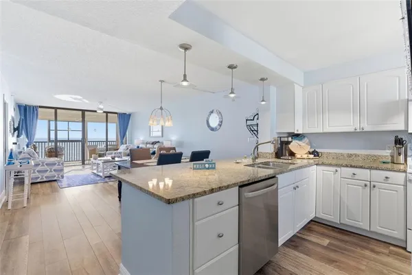 a living room with furniture large window and wooden floor