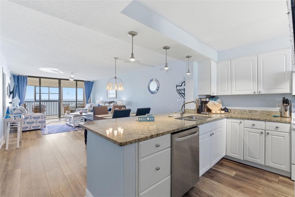 15462 Gulf Boulevard, Unit 406 Madeira Beach, FL 33708 - Photo 8 of 48 a kitchen with a sink stove and view living room