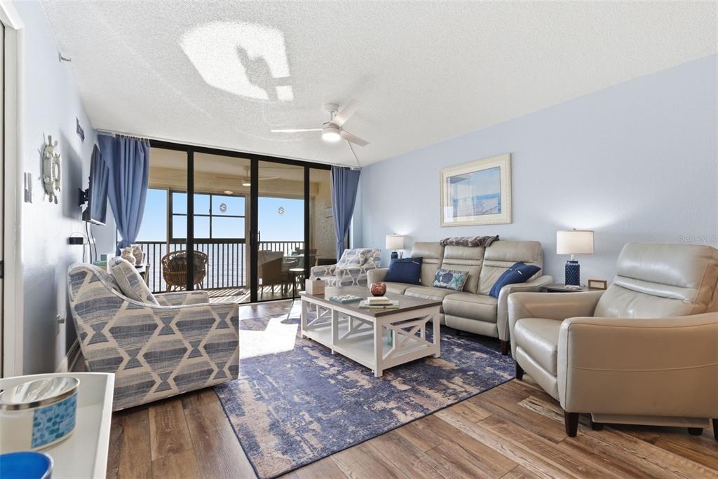 15462 Gulf Boulevard, Unit 406 Madeira Beach, FL 33708 - Photo 9 of 48 a living room with furniture large window and wooden floor