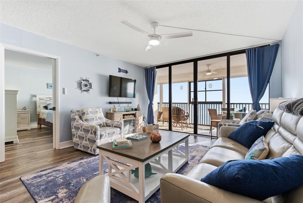 15462 Gulf Boulevard, Unit 406 Madeira Beach, FL 33708 - Photo 10 of 48 a living room with furniture and a flat screen tv
