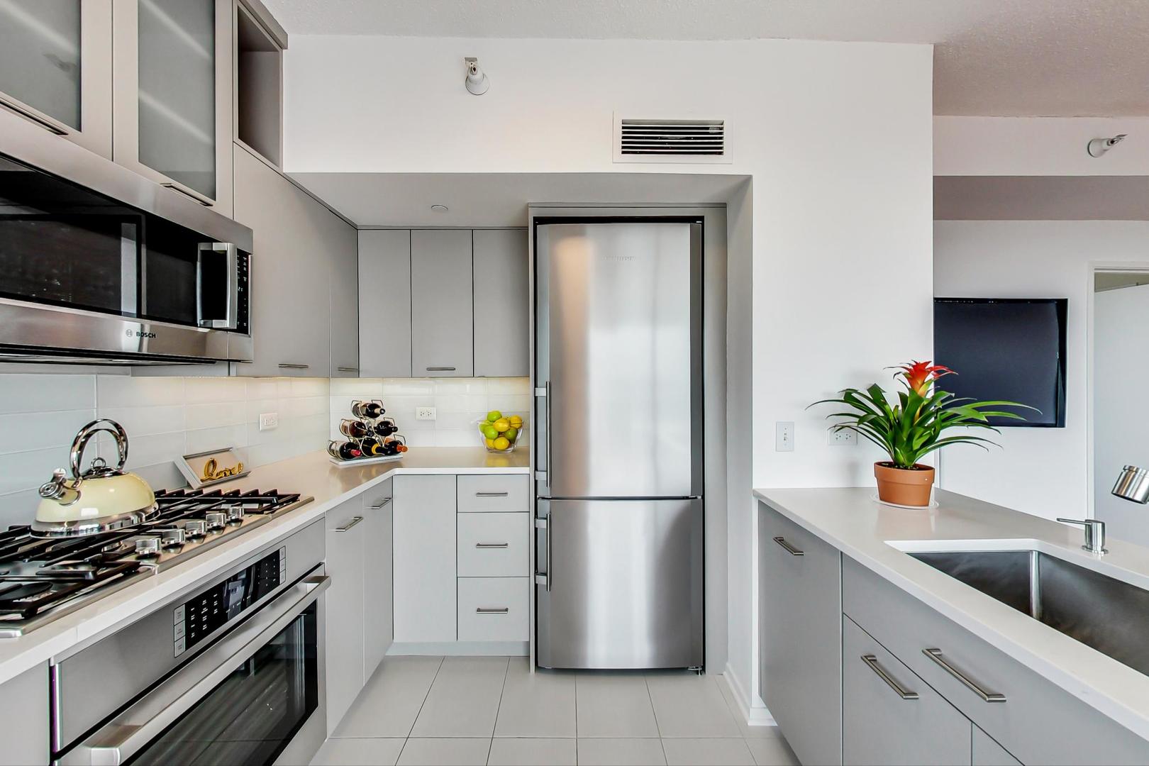 1720 Maple Avenue, Unit 2740 Evanston, IL 60201 - Photo 11 of 63 a kitchen with a refrigerator and a stove top oven