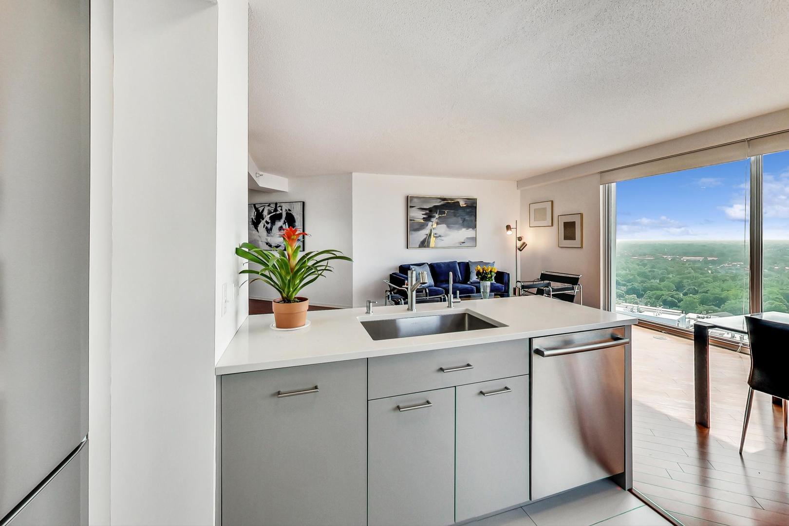 1720 Maple Avenue, Unit 2740 Evanston, IL 60201 - Photo 13 of 63 a kitchen with white cabinets and a window
