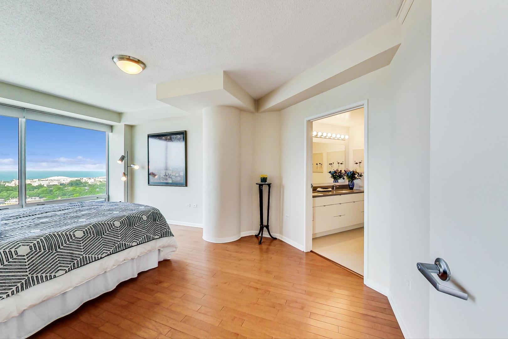 1720 Maple Avenue, Unit 2740 Evanston, IL 60201 - Photo 14 of 63 a spacious bedroom with a bed and a view of kitchen