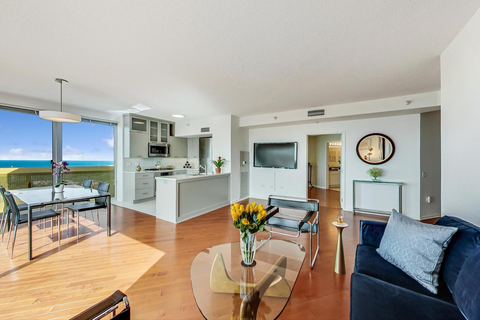 1720 Maple Avenue, Unit 2740 Evanston, IL 60201 - Photo 5 of 63 a living room with furniture a rug and kitchen view