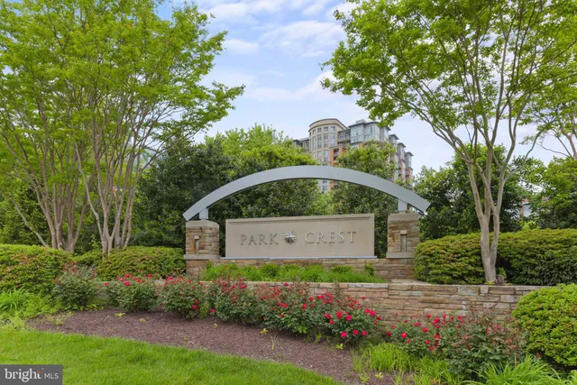 a front view of a house with a yard and fountain