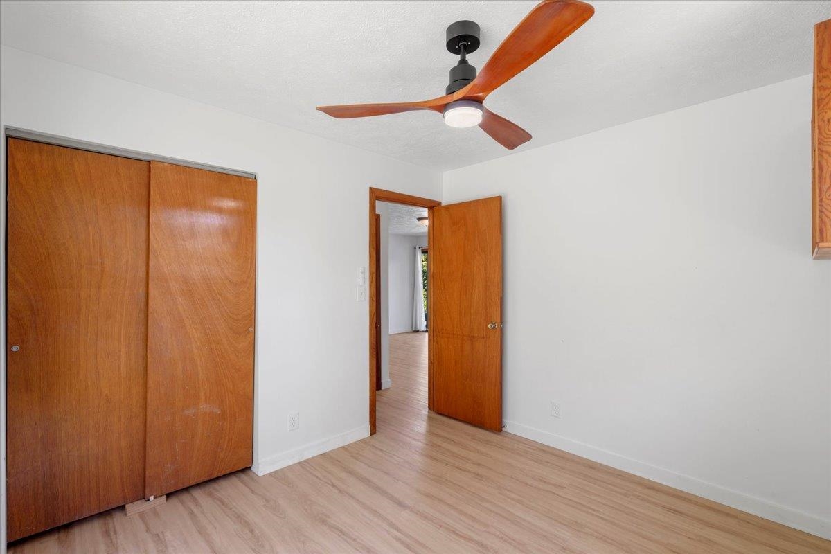 2130 Kauhikoa Road, Unit A Haiku, HI 96708 - Photo 23 of 43 an empty room with wooden floor closet and windows
