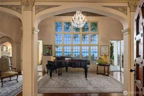 a living room with furniture and a chandelier
