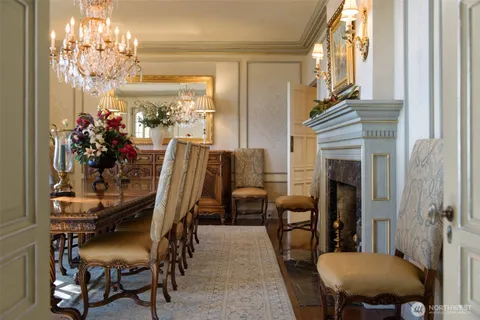 a view of a dining room with furniture and chandelier