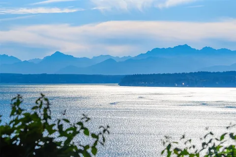 a view of mountain with sunset in background