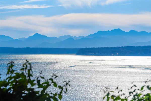 a view of mountain with sunset in background