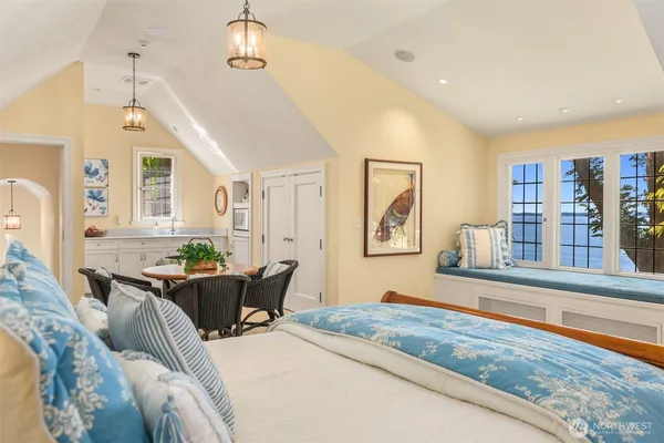 a front view of a house with a yard and potted plants