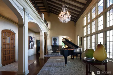 a living room with furniture and a chandelier