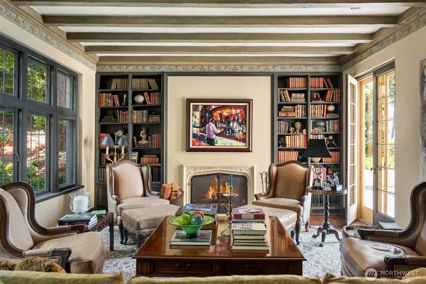 a living room with furniture a bookshelf and a large window