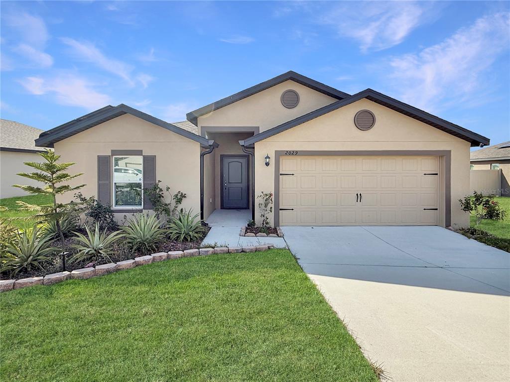 a front view of house with yard and green space