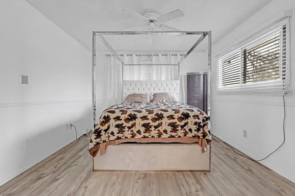 a view of a hallway with wooden floor and closet