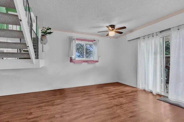 a view of a room with wooden floor