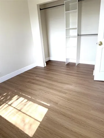 a bedroom with a bed and a refrigerator