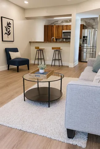 a living room with furniture and kitchen view