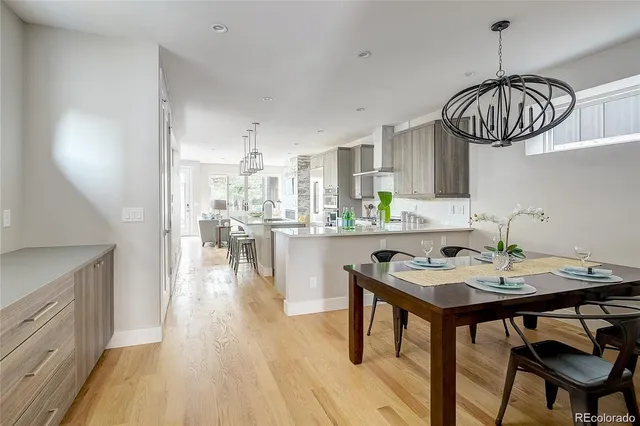 a kitchen with a dining table chairs sink and stove