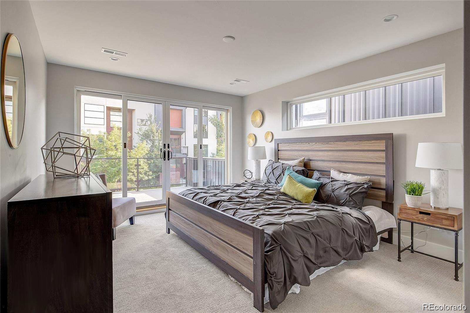 1811 West 32nd Avenue, Unit R Denver, CO 80211 - Photo 13 of 40 a bedroom with a bed and wooden floor