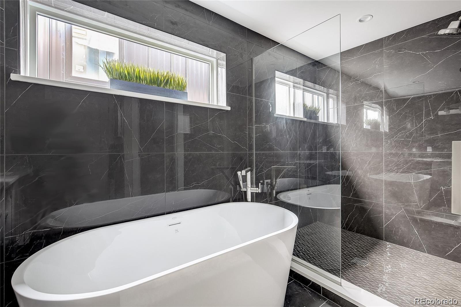 1811 West 32nd Avenue, Unit R Denver, CO 80211 - Photo 15 of 40 a white bath tub sitting next to a white sink