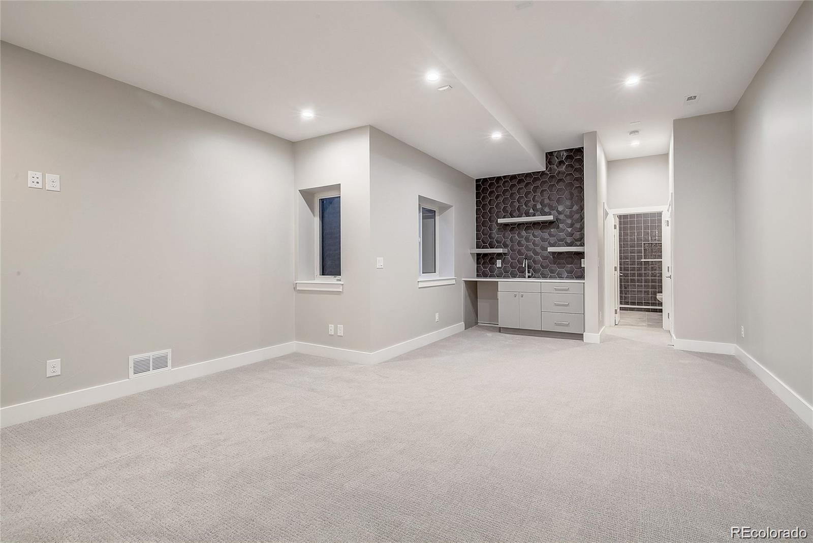 1811 West 32nd Avenue, Unit R Denver, CO 80211 - Photo 22 of 40 an empty room with kitchen and windows