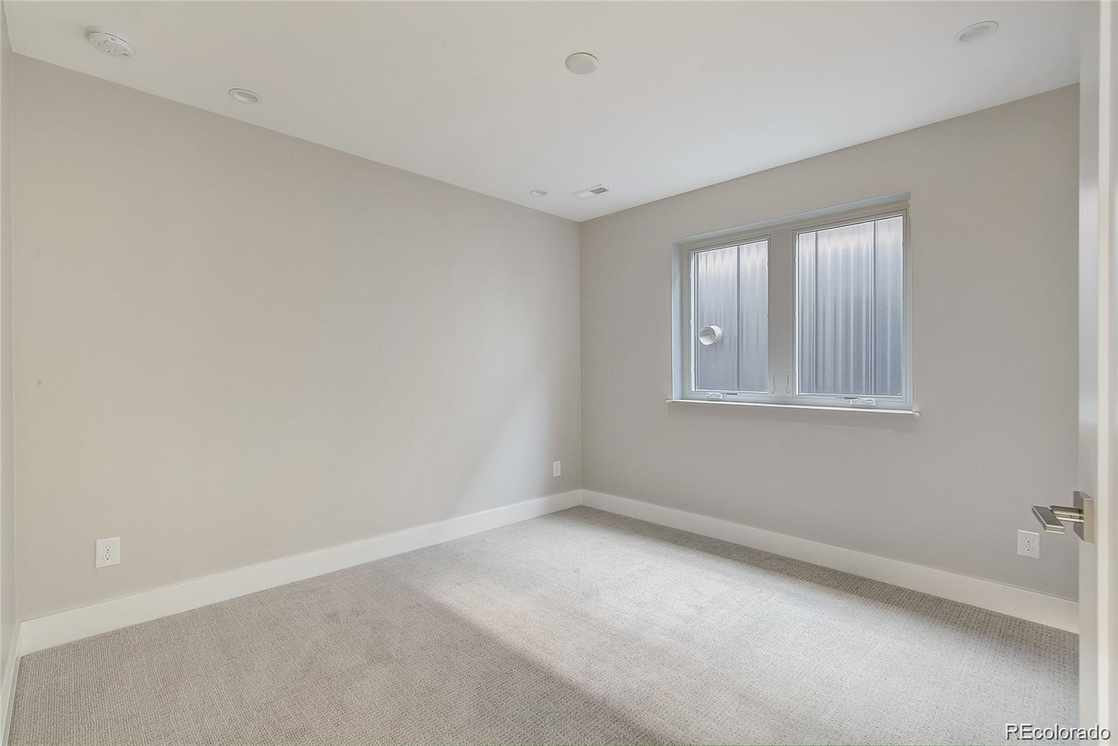 1811 West 32nd Avenue, Unit R Denver, CO 80211 - Photo 24 of 40 a view of an empty room with a window
