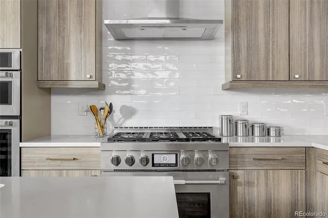 a close view of stove with granite countertop white cabinets and a stove