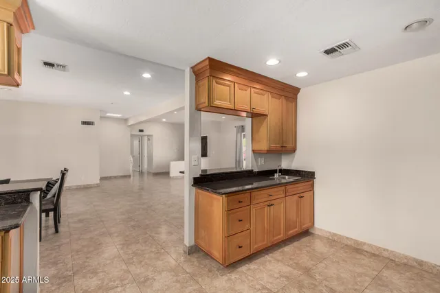 a kitchen with stainless steel appliances granite countertop a stove and a sink