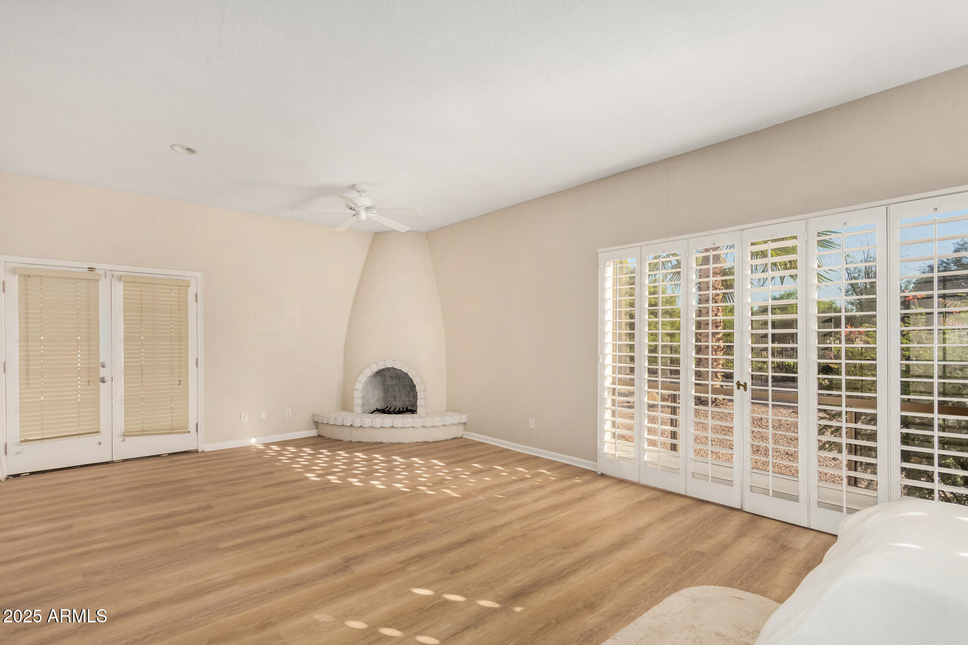 5739 East Cactus Road Scottsdale, AZ 85254 - Photo 17 of 52 a view of empty room with wooden floor and fan
