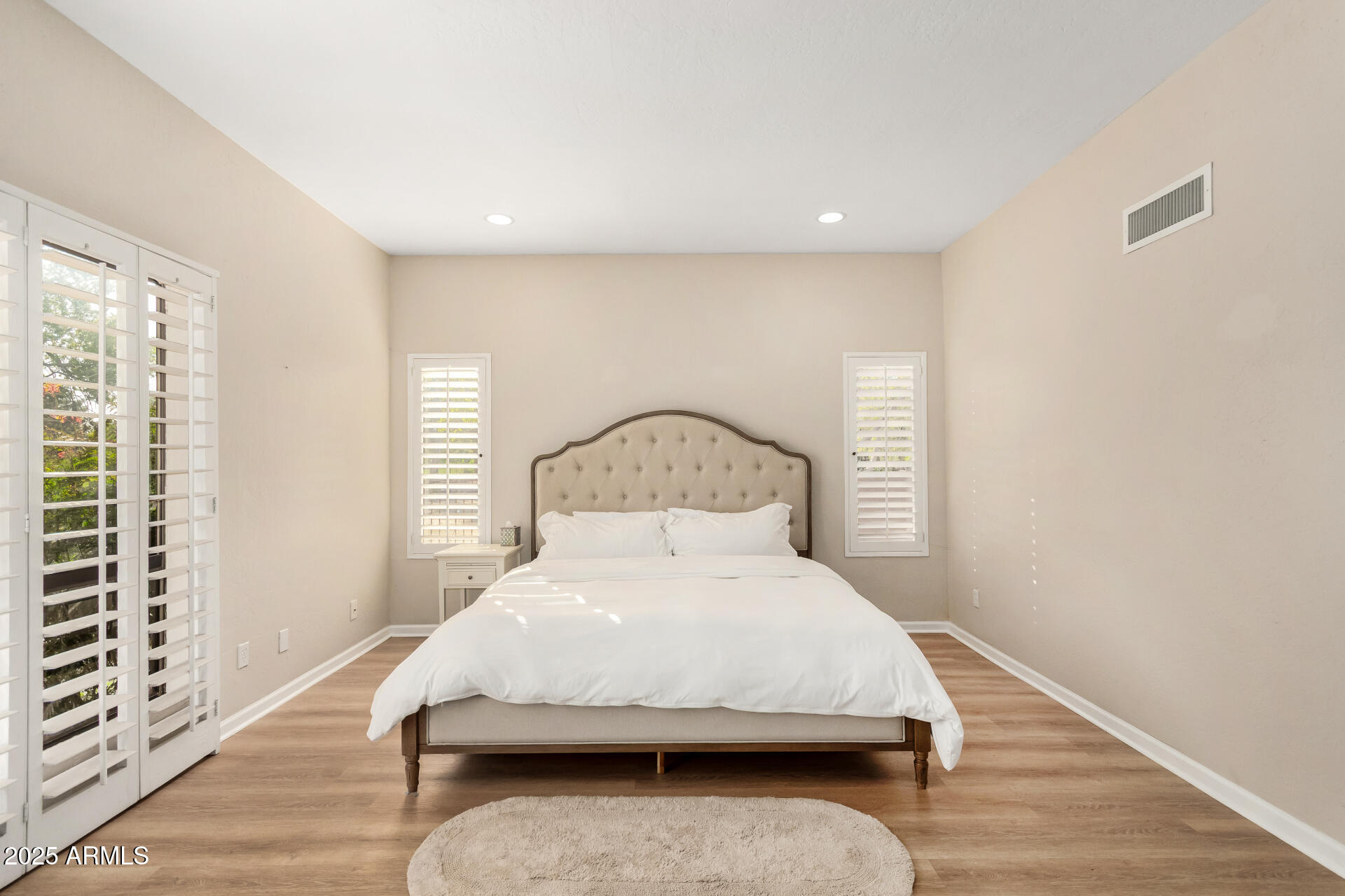 5739 East Cactus Road Scottsdale, AZ 85254 - Photo 18 of 52 a bed sitting in a room next to a window