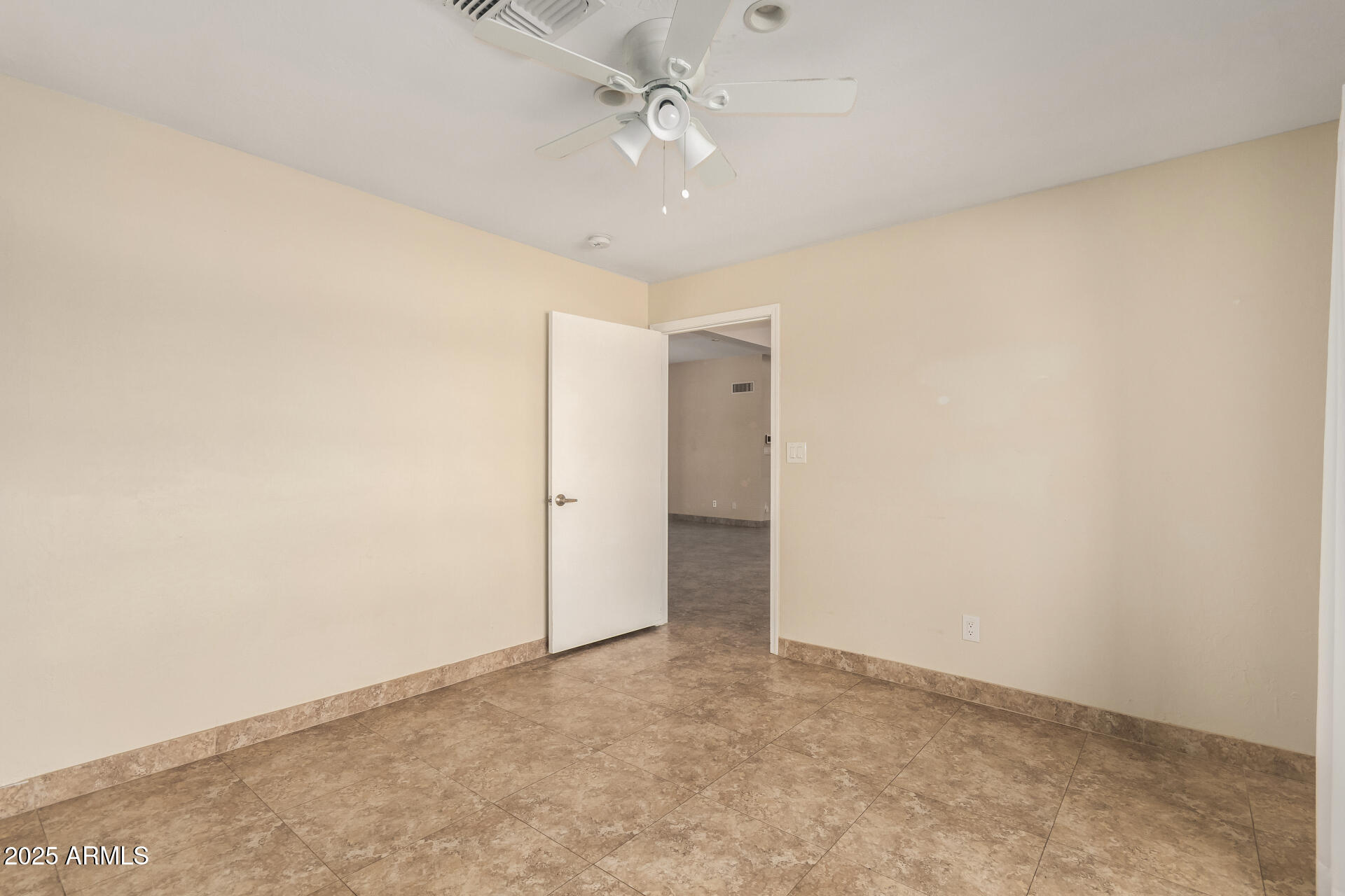 5739 East Cactus Road Scottsdale, AZ 85254 - Photo 22 of 52 an empty room with a ceiling fan and carpet