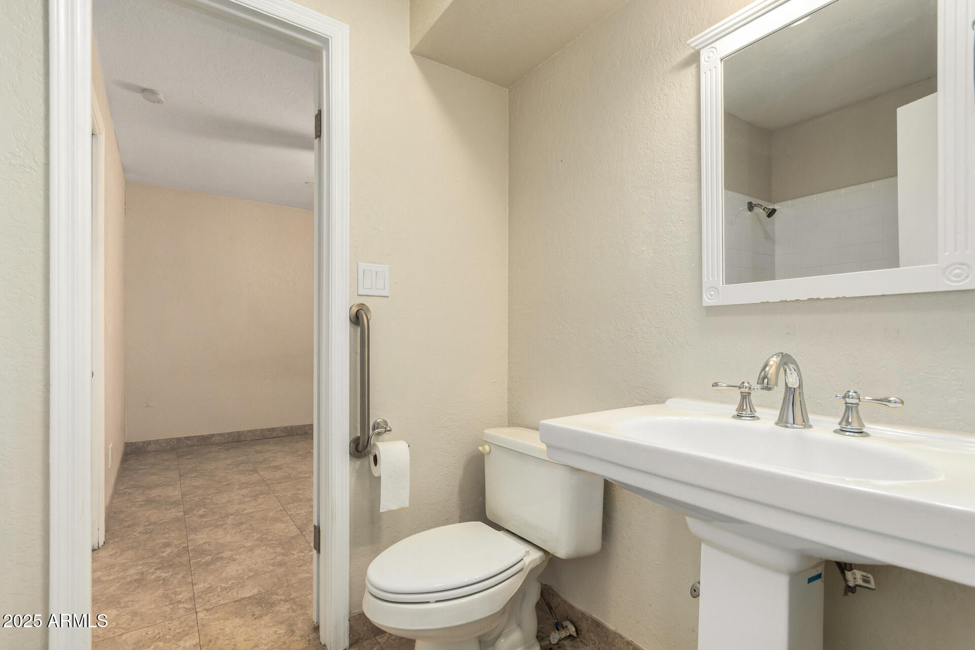 5739 East Cactus Road Scottsdale, AZ 85254 - Photo 25 of 52 a bathroom with a sink a toilet and shower