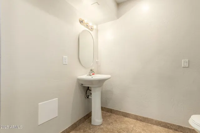 an empty room with a chandelier fan